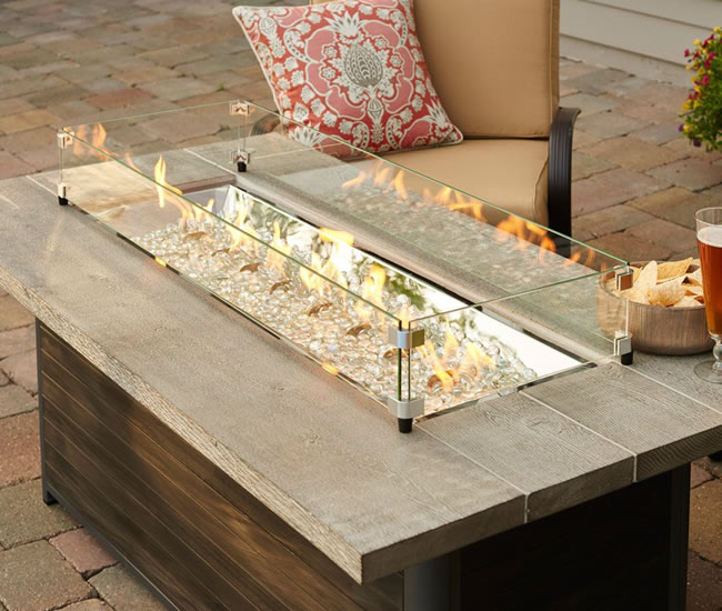 an image of a fire pit table with a wind guard